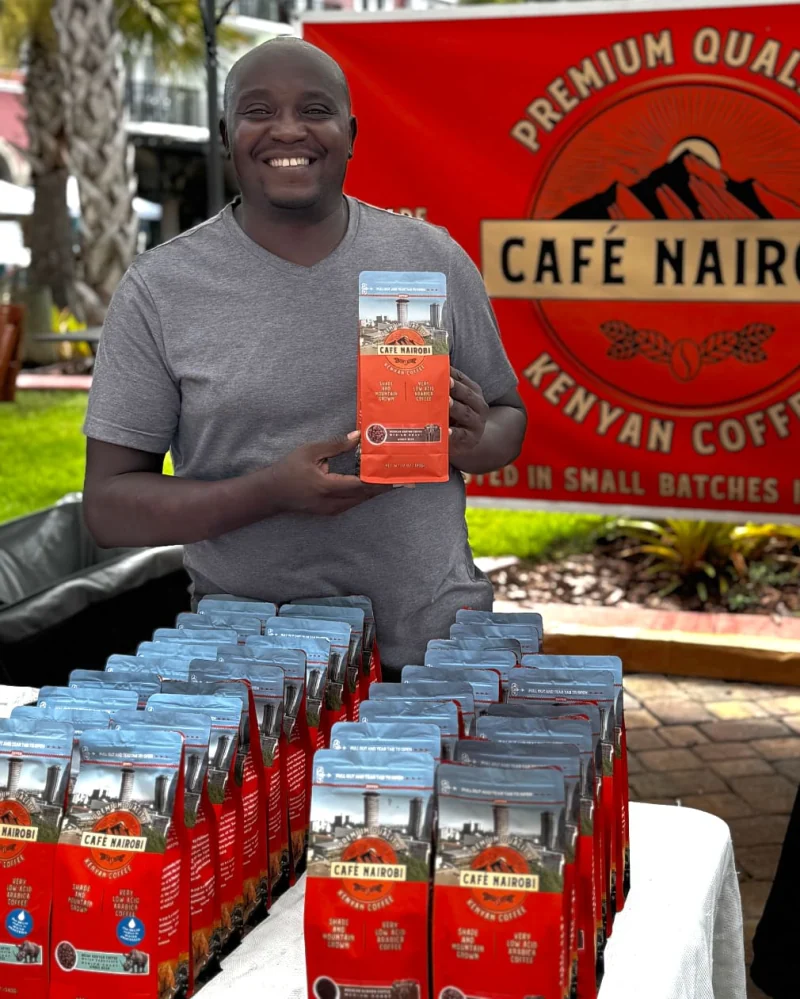 Martin Kabaki holding a Caf&eacute; Nairobi coffee bag at Palm Coast Farmers Market