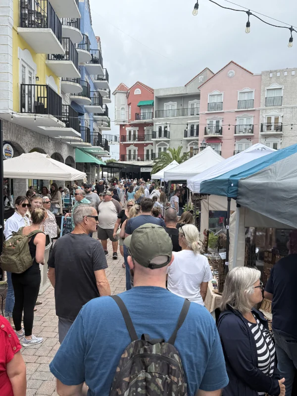 Crowd walking through the European Village market.