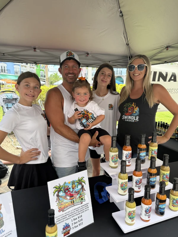 Swindle Sauce market booth with bottled sauces.